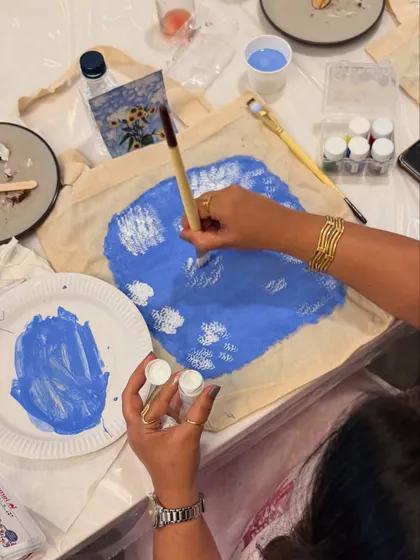 A close-up of the sunflower tote bag painting process. The layering of colors brings the design to life.