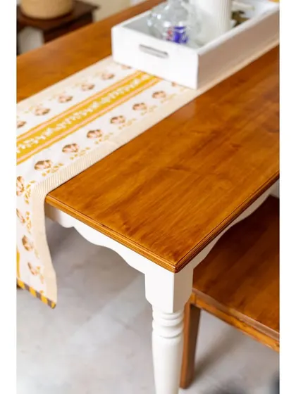 The rich finish on this dual-tone dining table highlights the beauty of the wood.