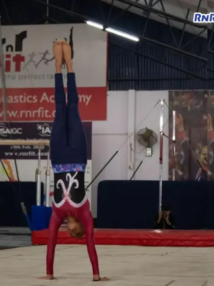 A perfectly executed handstand, showcasing the core strength and balance fundamental to gymnastics. Our athletes prove their grit and determination at every competition.