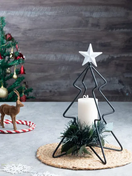 My metal Christmas tree stand with a white pillar candle is a simple yet stunning piece of decor.