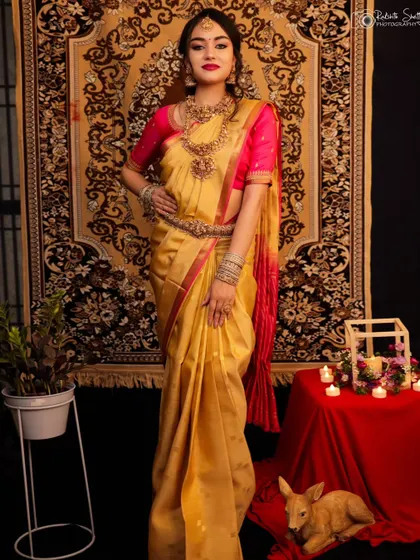 A full-length portrait of a model in a stunning golden saree. The traditional decor and her elegant pose create a classic and regal image, perfect for a bridal portfolio.