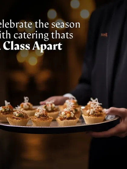 A server presents a tray of beautifully crafted cupcakes, perfect as a pass-around dessert.