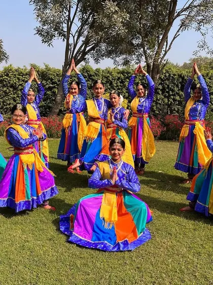 The final pose of a beautiful outdoor performance. The colorful costumes and synchronized postures create a stunning visual.