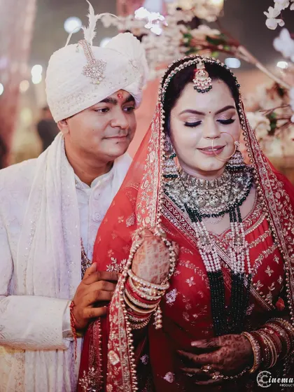 Another beautiful portrait of the couple, capturing their serene expressions and the rich details of their wedding outfits.