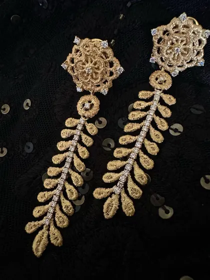 My favorite classic danglers, designed to be feathery light. These earrings are handcrafted in 18k gold with a leaf like motif, accented with a line of natural diamonds for a touch of sparkle.