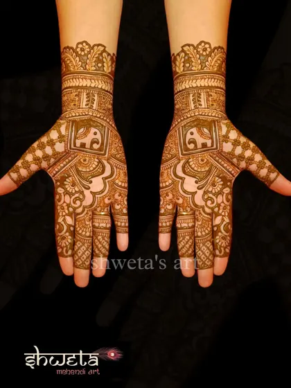 A simple and elegant design for the hands. It features a central elephant motif within a square frame, surrounded by delicate patterns that are perfect for a wedding guest.