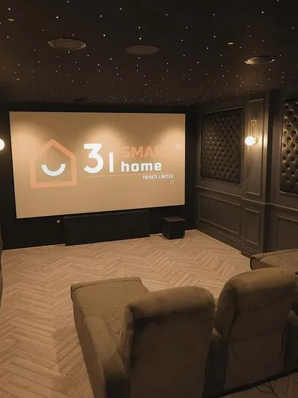 Another perspective of the room, showing the screen from the side and highlighting the depth and texture of the tufted wall panels.