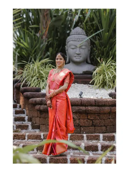 A solo portrait of the bride in her beautiful pink saree during her Goa Mehndi.