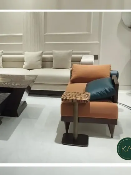 An eclectic living room arrangement featuring an orange armchair with a patterned side table and a neutral-toned sofa. This shows our versatility in combining different styles and colors to match a client's vision.
