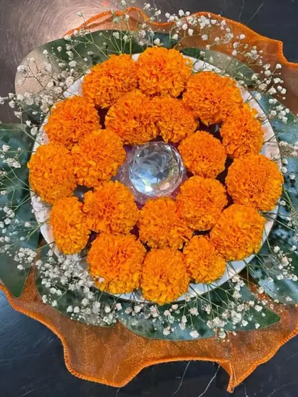 A beautiful floral centerpiece not only looks attractive but also adds a vibrant element of color to your table. This arrangement uses marigolds and baby's breath for a festive and cheerful look.
