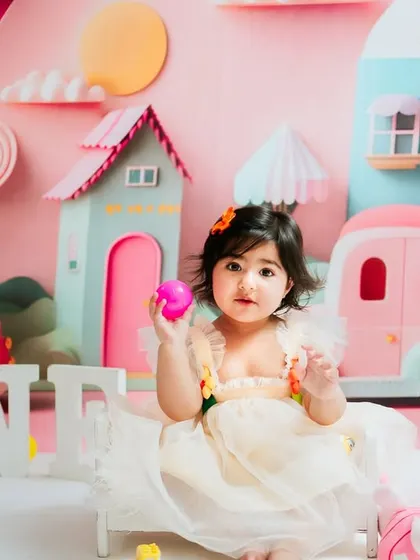 A calmer moment during the city-themed shoot. She sits sweetly amidst the colorful props, giving a lovely, gentle portrait.