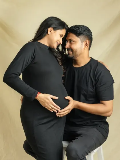 A beautiful, intimate moment. This pose, with your heads together and hands on the bump, creates a heart shape that perfectly symbolizes your growing love.