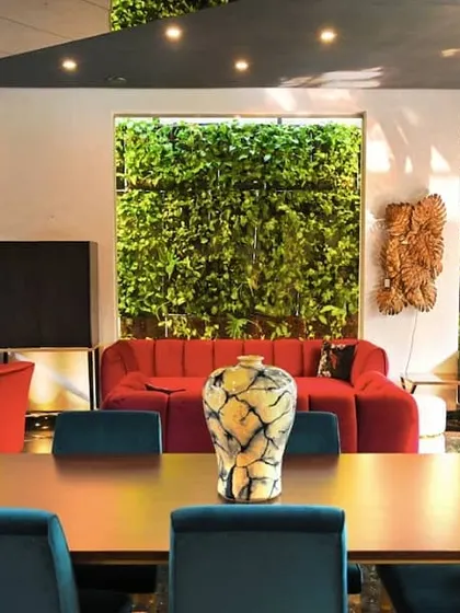 Another view from inside the Cane Boutique showroom, where the exterior vertical gardens are visible through every window. This design choice makes the greenery a constant, integral part of the interior decor and customer experience.