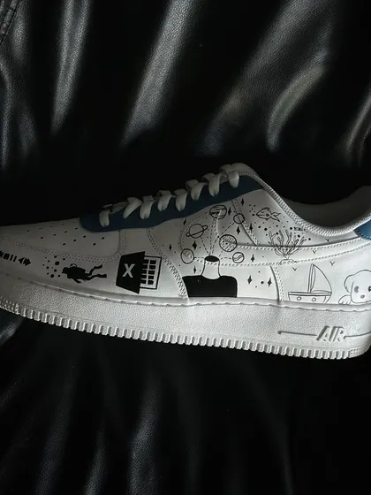 A side profile of the other shoe in the doodle custom pair.