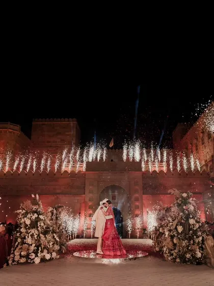 A moment suspended in time. Against the majestic backdrop of Suryagarh, we framed the couple's union with a symphony of light and fireworks, creating a magical embrace that sealed their love story forever.