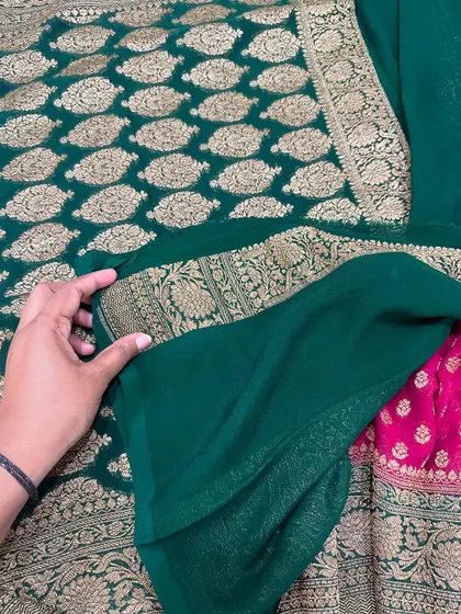 A beautiful bottle green and rani pink pure Banarasi Kadi georgette saree. The contrast of the rich gold weaving against the deep green is absolutely stunning.