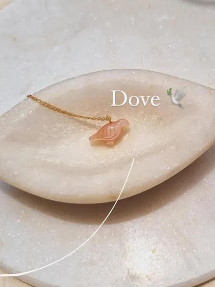The 'Dóve' pendant in Peach Moonstone, a stone for peace, abundance, and good fortune.