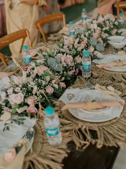 Every detail on the table is crafted to create a feeling of timeless romance. From the custom-printed menu to the delicate floral napkin rings, this setup invites guests to a truly special dining experience.
