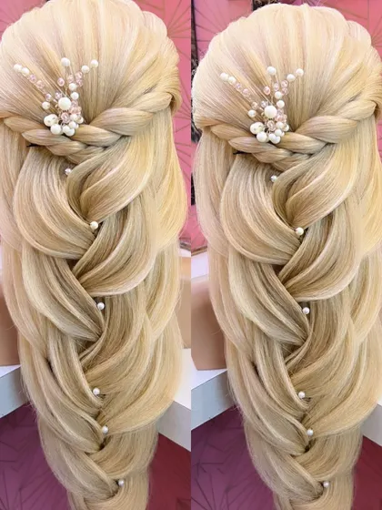 A finished look of the open hairstyle with a pearl-adorned braid.