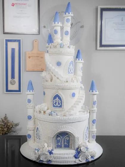 The full castle cake on display in my studio, showcasing its impressive height and detailed craftsmanship before it heads to the party.