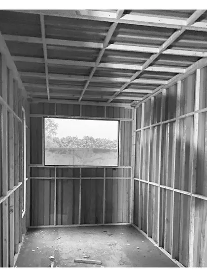 Another interior shot of the framing process. A large window has been framed, already connecting the inside of the container to the landscape outside.