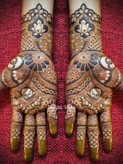 A beautiful symmetrical design with elephant motifs, lotus flowers, and intricate patterns.
