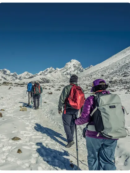 A team of trekkers navigating a snow-covered section of the Everest Base Camp trail. We prepare you for all conditions, ensuring you have the right gear and guidance for a safe winter trek.