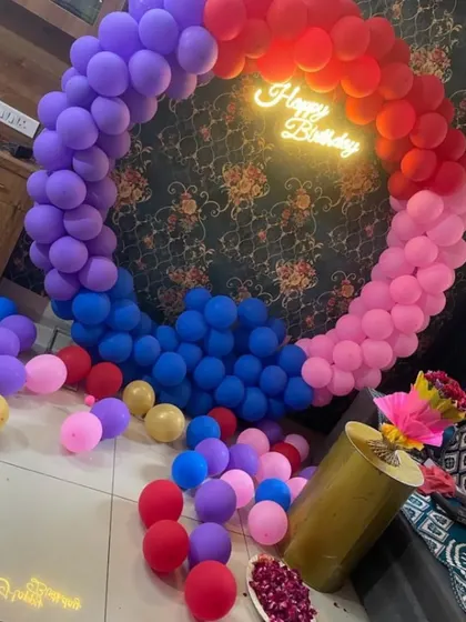 This vibrant, multi-colored balloon ring with a neon sign is one of my latest and most trending designs, available for only ₹3999. It's perfect for a fun and colorful birthday party.