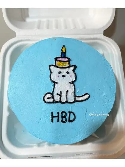A birthday cat with a candle on its head, a fun design for a bento cake.