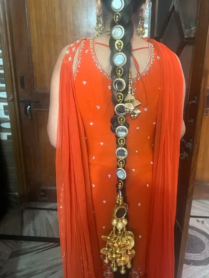 A full back view of the parandi braided into the hair, showing its length and the beautiful tassel at the end.