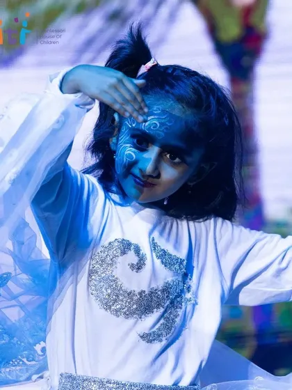 A child representing Vayu (Air) performs a graceful dance. The flowing costume and expressive face paint bring the element to life.