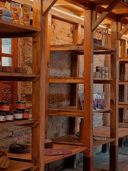 This detail of the custom shelving at the Sargakhet Handicraft Centre shows how we used simple, locally sourced wood to create a functional and beautiful display system. The design respects the rustic charm of the building while providing a platform for local artisans to sell their goods.