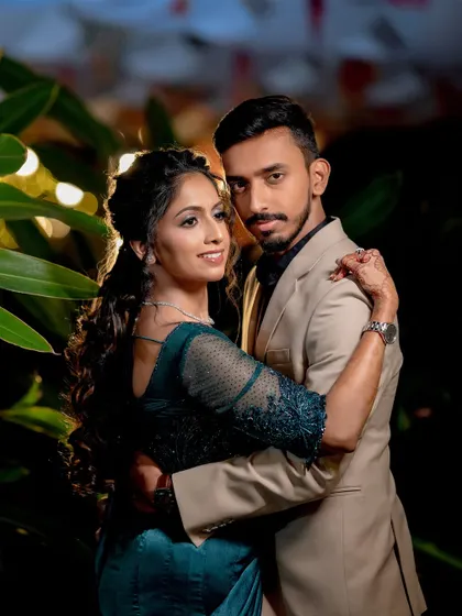 A stylish portrait of Sushma and Athmic at their Sangeet, with beautiful backlighting creating a dramatic effect.