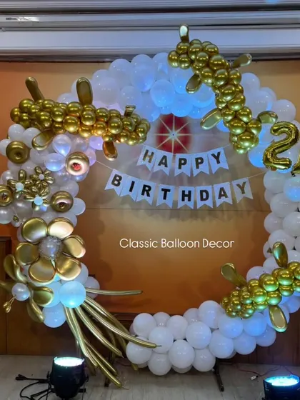 A highly creative and artistic dragon-themed balloon ring in white and gold for a 21st birthday.