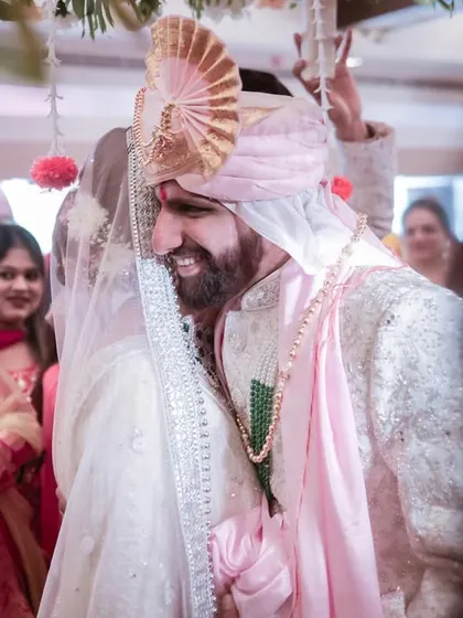 A candid shot of the groom's happy laugh during the wedding ceremony. These are the genuine, unposed moments we love to capture.