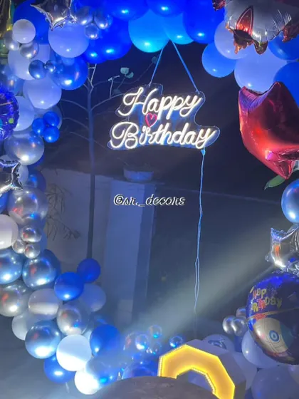 A close-up of the blue and silver balloon arrangement for the 'Space' theme, highlighting the mix of chrome, metallic, and star-shaped foil balloons.