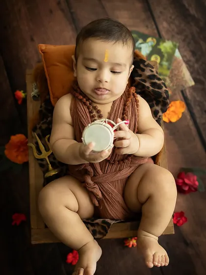 A moment of quiet contemplation. This baby is fascinated by the 'damru', a perfect detail for our Shiva-themed shoot.