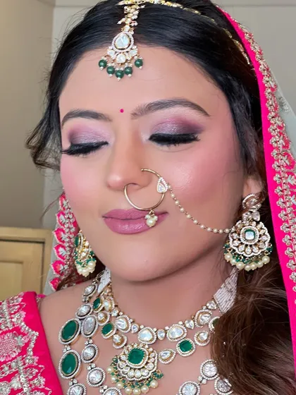 A close-up of the eye makeup for this look. The shimmery pink and purple tones create a dramatic and beautiful effect.