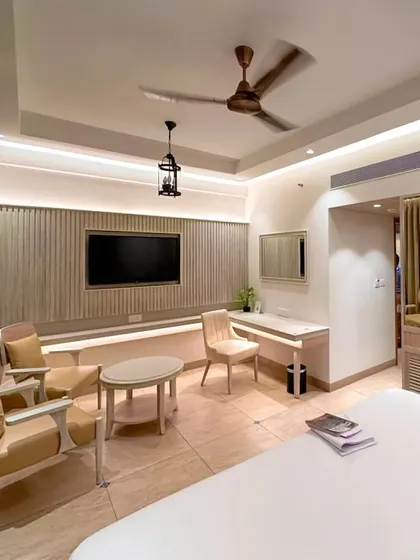 This view of the Goa guest room highlights the functional layout, including a comfortable seating area, a sleek work desk, and ample space for relaxation.