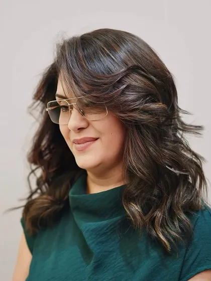 A vibrant and edgy look on medium-length hair. The combination of layers and subtle highlights creates a bold and stylish result.