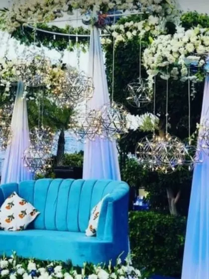 This decor, with its cool blue sofa and white floral hangings, is perfect for a pre-wedding function. We love thinking out of the box to create themes that resonate with your personality.