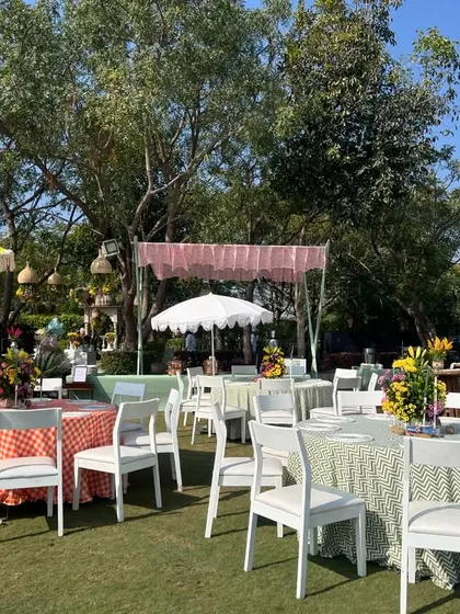 A wide shot of the outdoor lunch area, showing a mix of colorful tablecloths and umbrellas, creating a festive and casual dining experience.