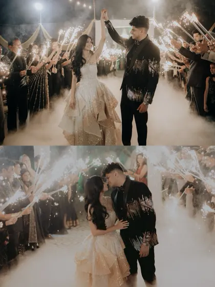 The couple's grand entrance to the reception, walking through an arch of sparklers held by their guests.