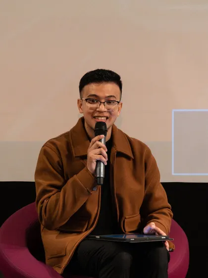 A young poet sharing his work during the 'Verse & Voice' showcase. Our workshops are designed to build the confidence needed to command the stage.