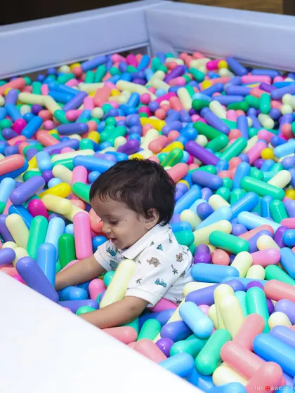 A little one having a blast in a colorful ball pit. We often include fun zones like this to ensure the youngest guests have a safe and exciting space to play.