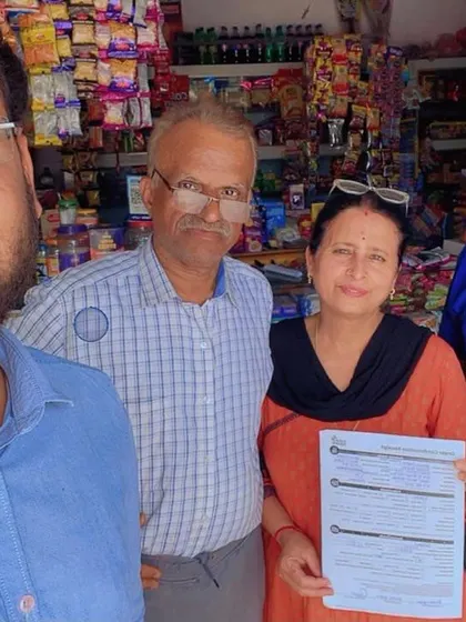 Our team with a family outside their shop, holding their new solar agreement. We support local businesses in their transition to clean energy.