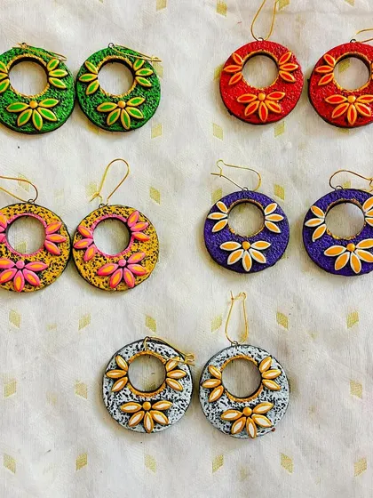 Large, circular hoop earrings with floral motifs. These are lightweight statement earrings that are perfect for making an impression.