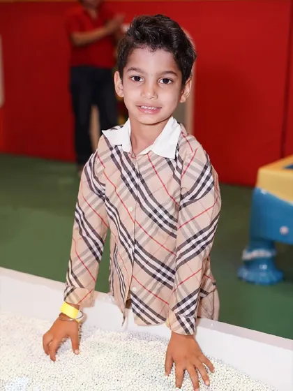 Another happy guest enjoying the sensory experience of our kinetic sand table.