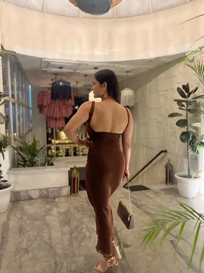 A back pose in my evening dress, showing the muscle I've built.