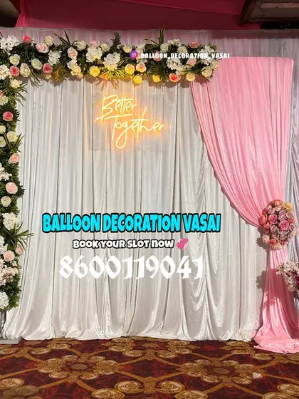 This asymmetrical L-shaped floral arch adds a modern twist to a classic engagement backdrop. The soft pink drape complements the flowers and adds a touch of elegance.